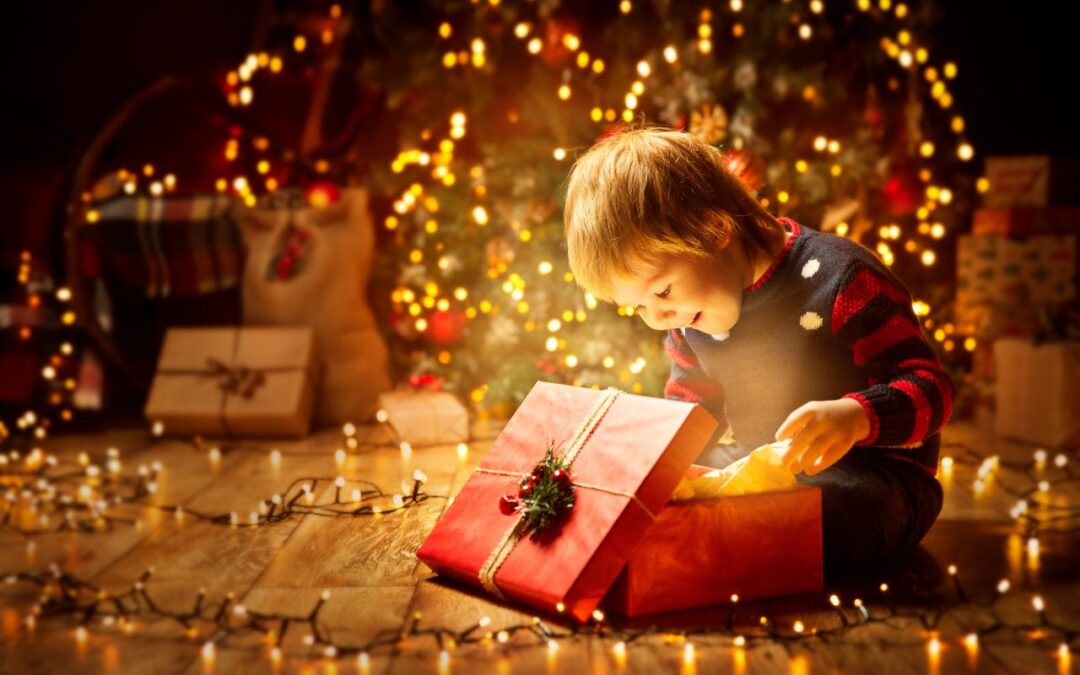 A baby boy unrapping his gift